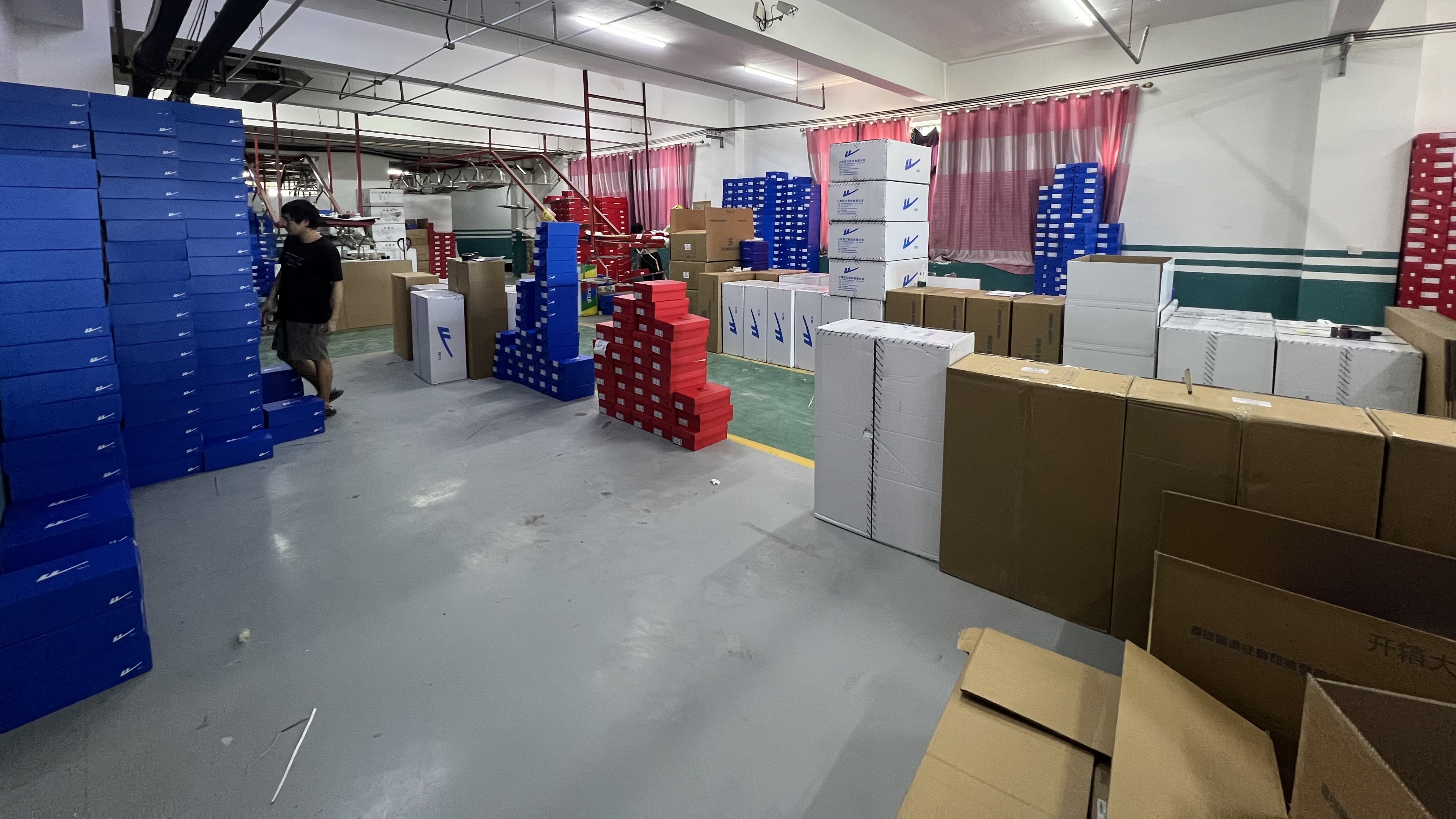 Mingjian warehouse stacked with branded shoe boxes ready for packing